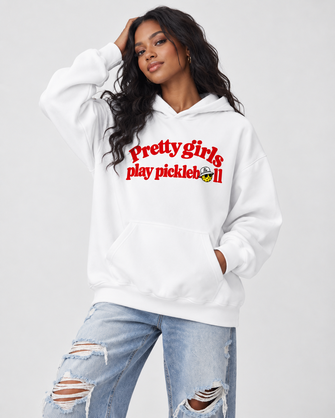 Model wearing a white Pretty Girls Play Pickleball hoodie with jeans
